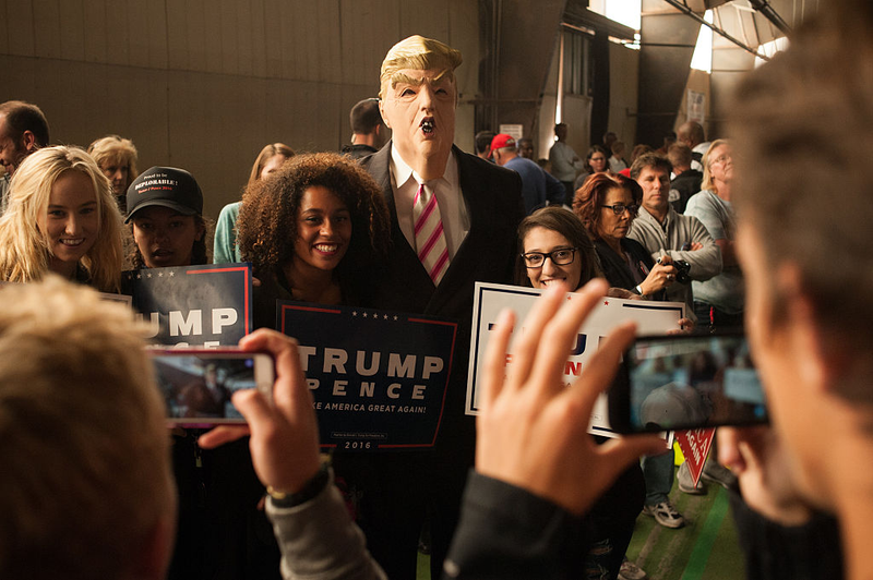 Tom Lazzaro of Colorado Springs, wears a Donald Trump mask while posing with other crowd members at a Trump rally on October 18, 2016 in Colorado Springs (Photo by Theo Stroomer/Getty Images)